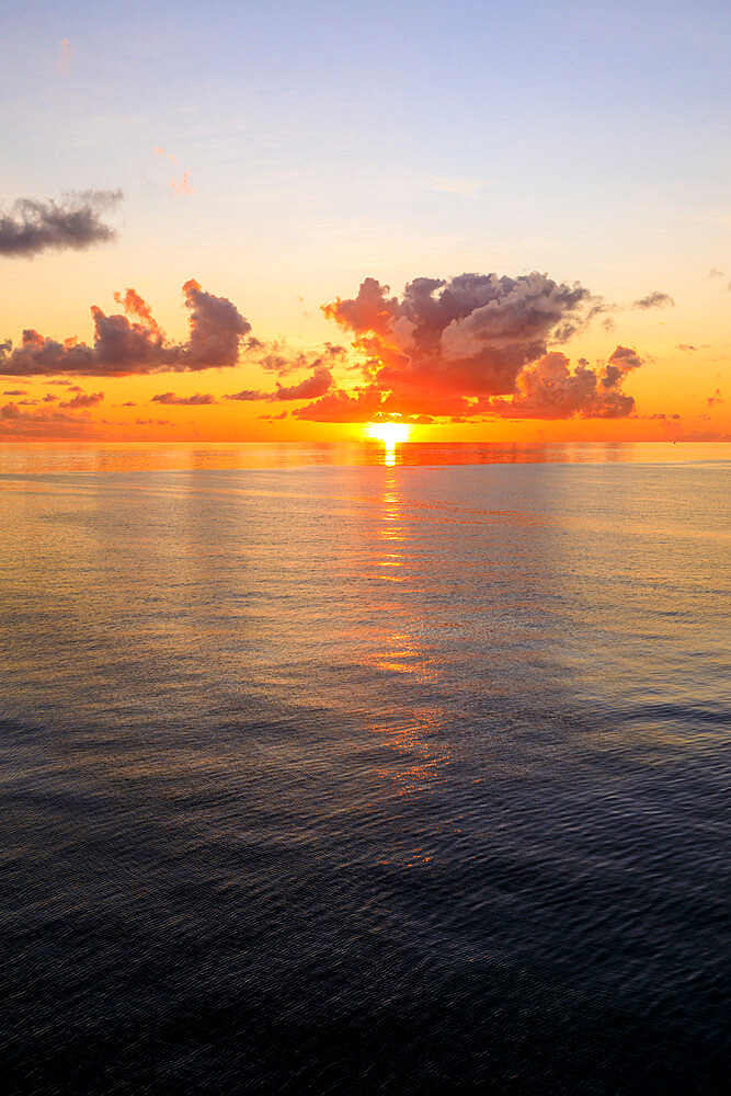 Sunset over beautiful calm sea, interesting clouds, vibrant colours, St. Kitts, St. Kitts and Nevis, Leeward Islands, West Indies, Caribbean, Central America