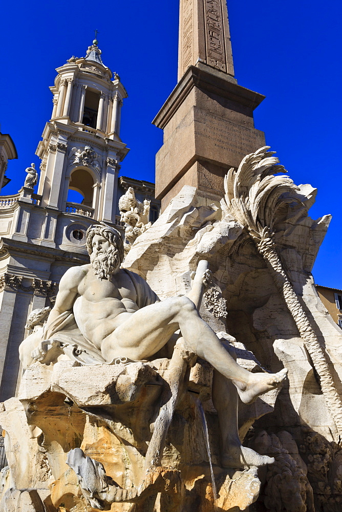 Fontana dei Quattro Fiumi, topped by the Obelisk of Domitian with the Sant'Agnese in Agone, Piazza Navona, Rome, Lazio, Italy, Europe