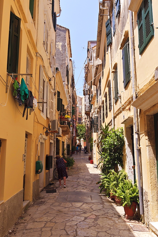 Narrow street with lady sweeping, Old Town, Corfu Town, UNESCO World Heritage Site, Corfu, Ionian Islands, Greek Islands, Greece, Europe