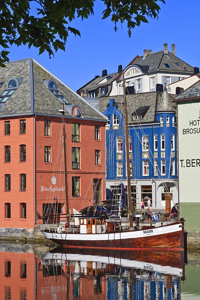 Art Nouveau buildings and reflections with boat, Alesund, More og Romsdal, Norway, Scandinavia, Europe