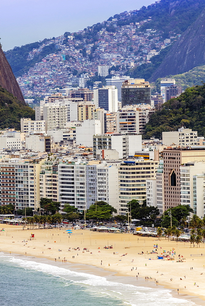 Elevated view of Copacabana Beach, apartment blocks and the Pavao Pavaozinhao favela slum, Rio de Janeiro, Brazil, South America