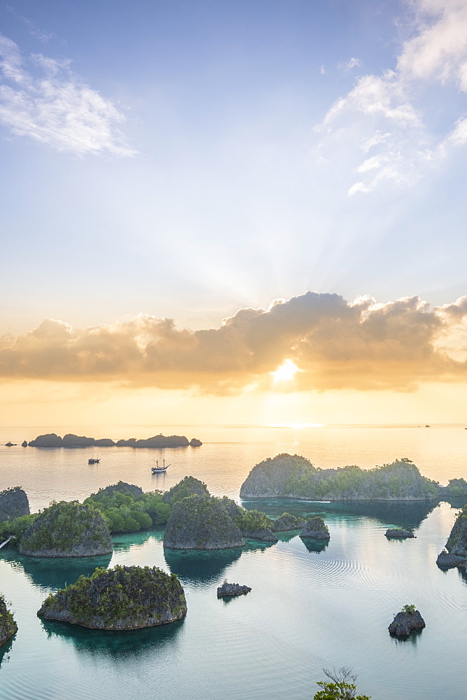 View over a bay of islands at dawn from the Piaynemo lookout, Raja Ampat, West Papua, Spice Islands, Indonesia, Southeast Asia, Asia