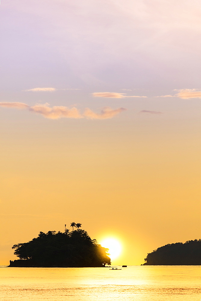 The sun setting behind islets in the Banda archipelago, Banda, Maluku, Spice Islands, Indonesia, Southeast Asia, Asia