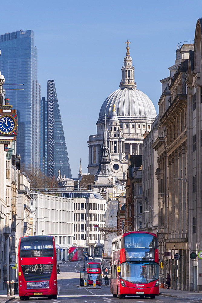 Red double-decker buses on Fleet Street with the dome of St. Paul's Cathedral and skyscrapers in the financial district of City of London, London, England, United Kingdom, Europe