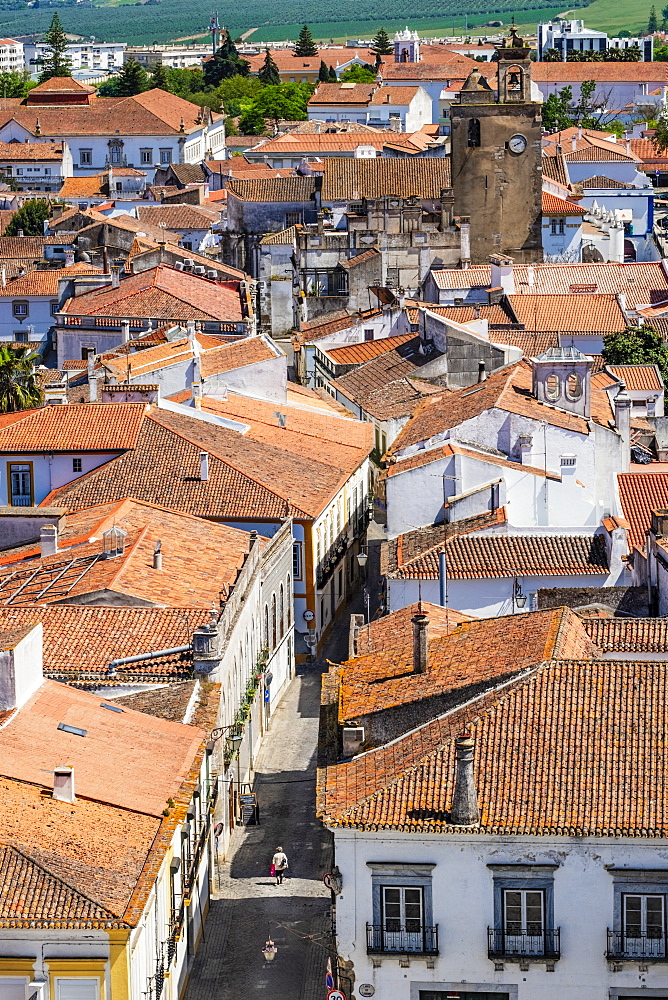 A woman walking down a deserted street in the historical centre, Beja, Alentejo, Portugal, Europe