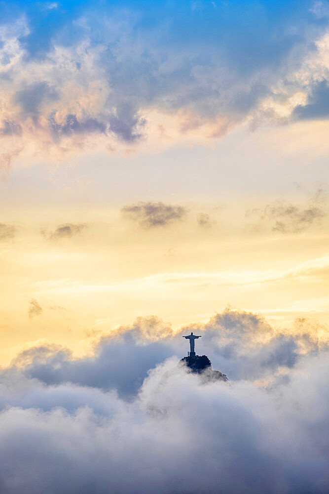 The Christ Statue (Cristo Redentor) on the summit of Corcovado mountain in a sea of clouds, Rio de Janeiro, Brazil, South America