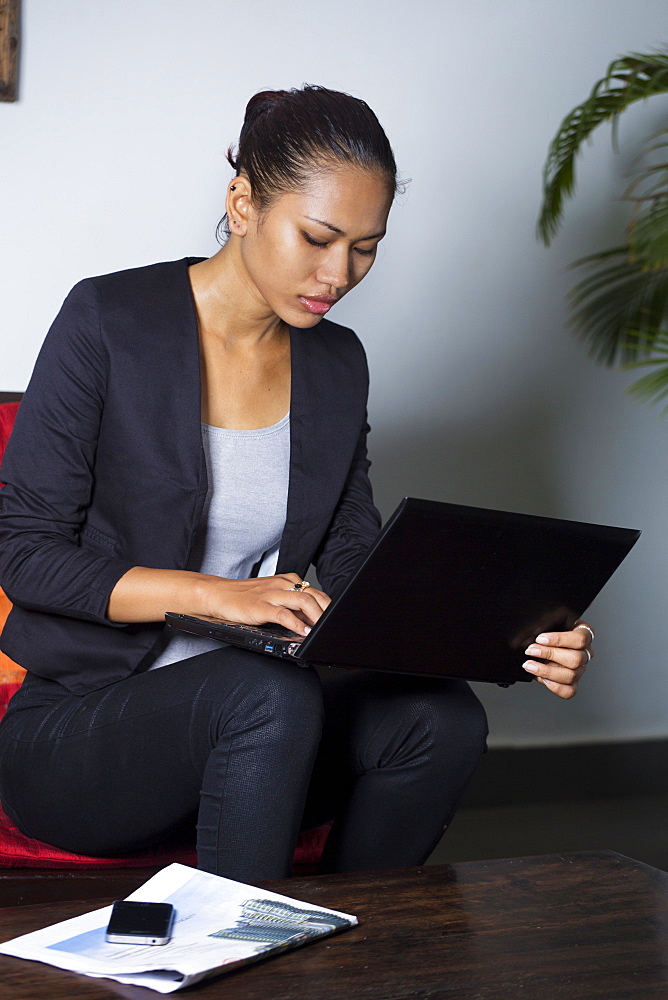 Young South East Asian woman, a Cambodian business traveller with laptop, Cambodia, Southeast Asia, Asia