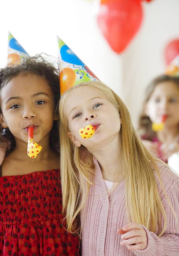 Multi-ethnic girls at birthday party