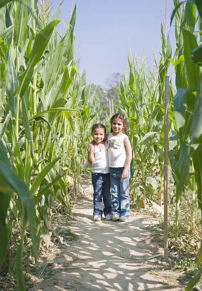 Hispanic sisters in corn field