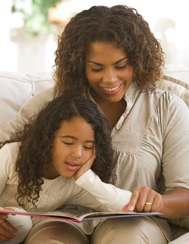 African mother and daughter reading