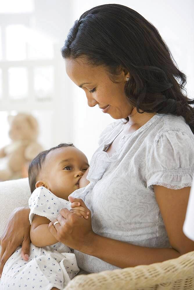 African American mother breastfeeding baby