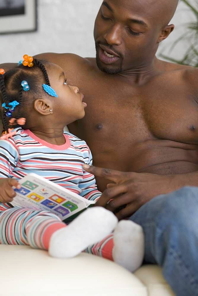 African father reading to daughter