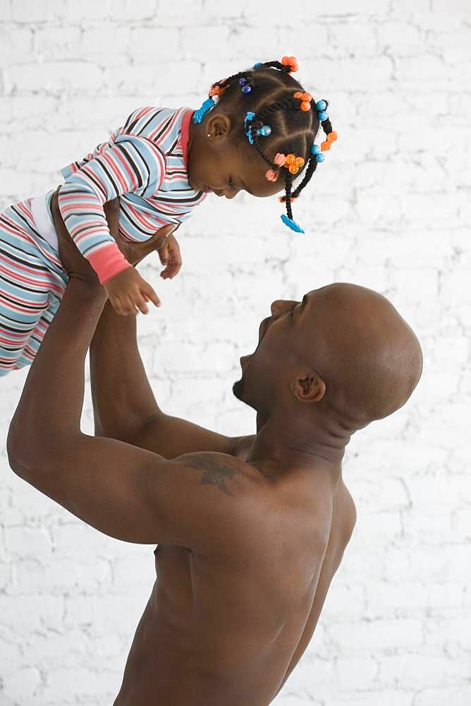 African father playing with daughter