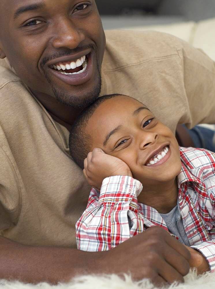 African father and son hugging