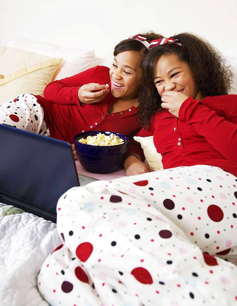 African twin sisters watching movie