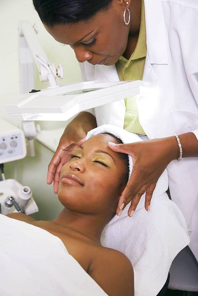 African woman receiving spa facial treatment