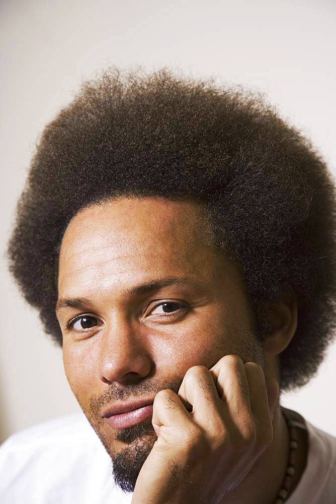 African man resting chin on hand