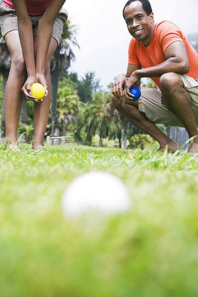 African couple playing bocci ball