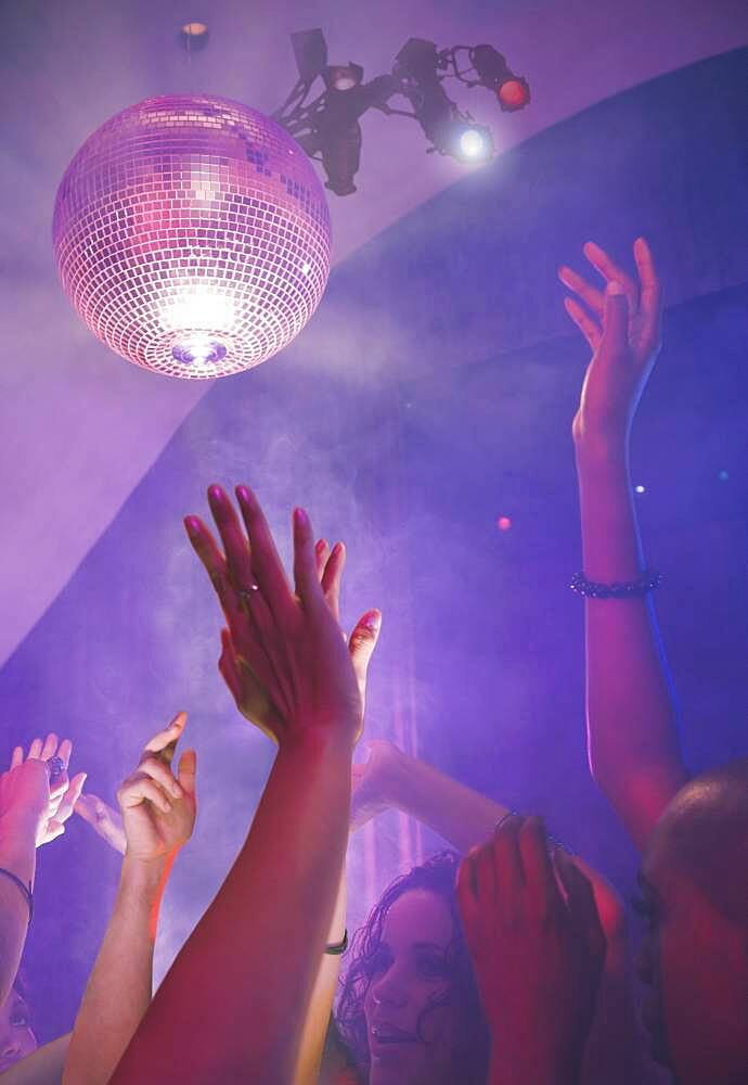 Multi-ethnic people dancing at nightclub