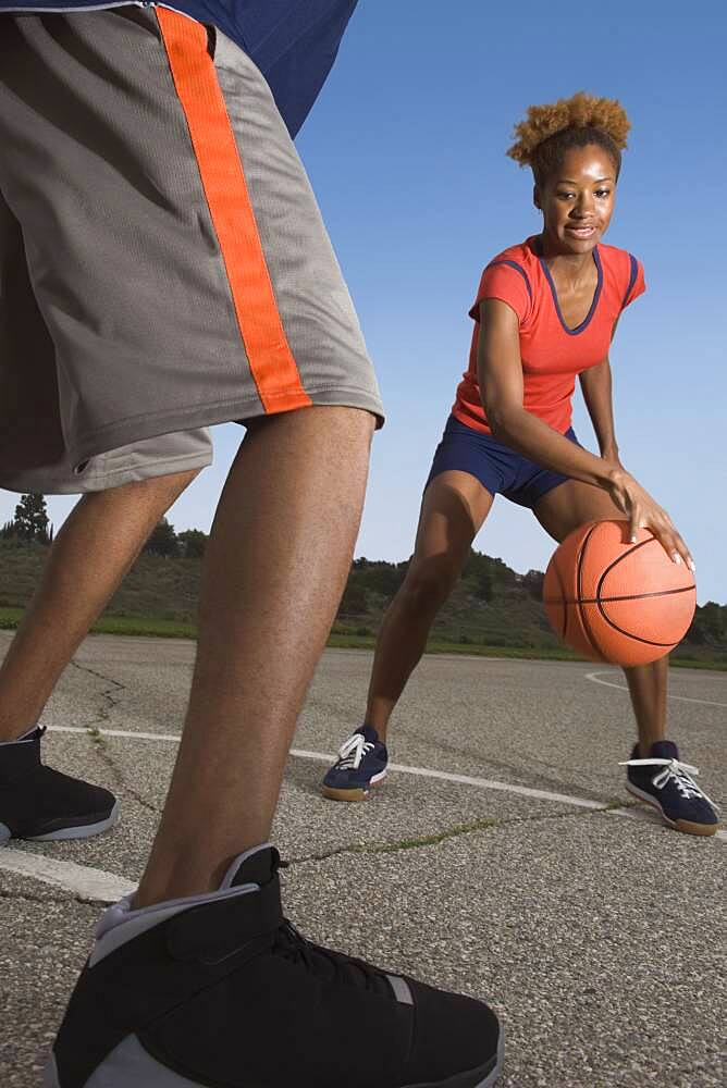 African woman playing basketball