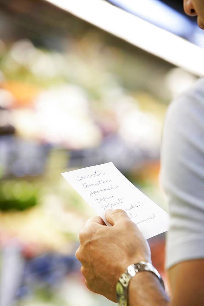 Hispanic man reading grocery list