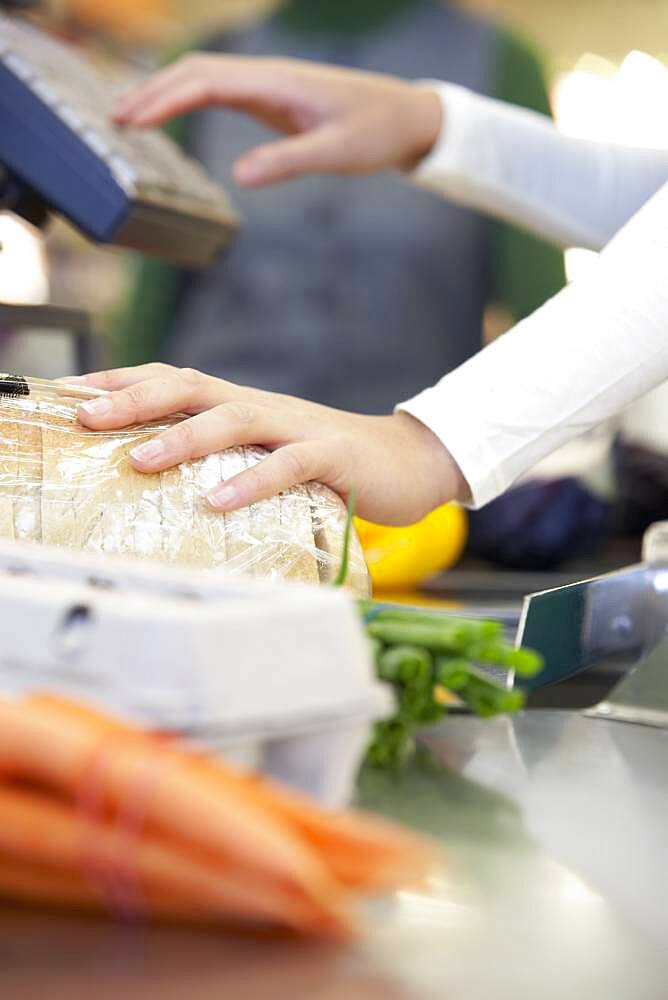 Cashier ringing up groceries