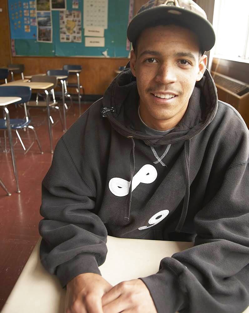 Young African man sitting in classroom