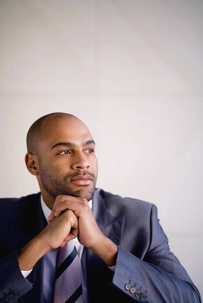 African businessman resting chin on hands