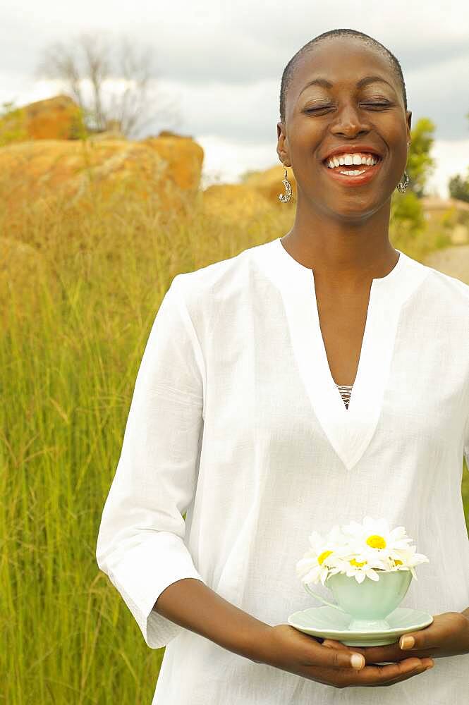 African American woman with teacup outdoors