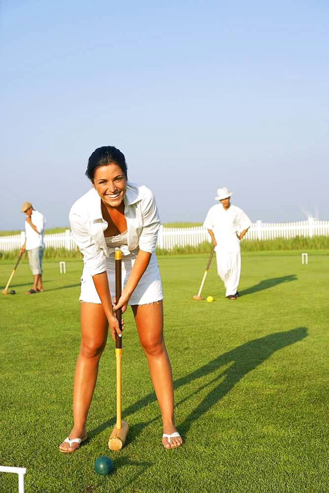 Young woman playing croquet