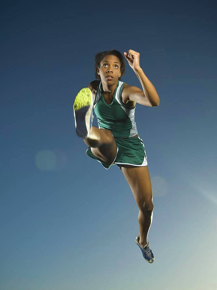 African American female athlete jumping