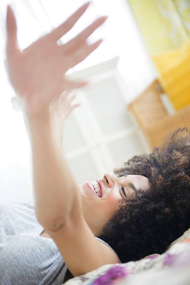 Mixed race woman laying on bed