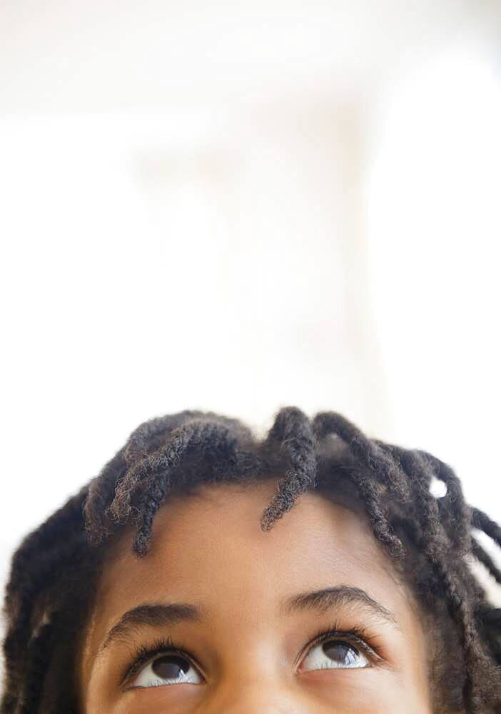 Close up of mixed race boy looking up