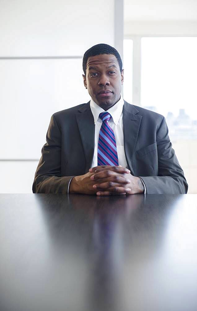 Businessman sitting at conference table in meeting