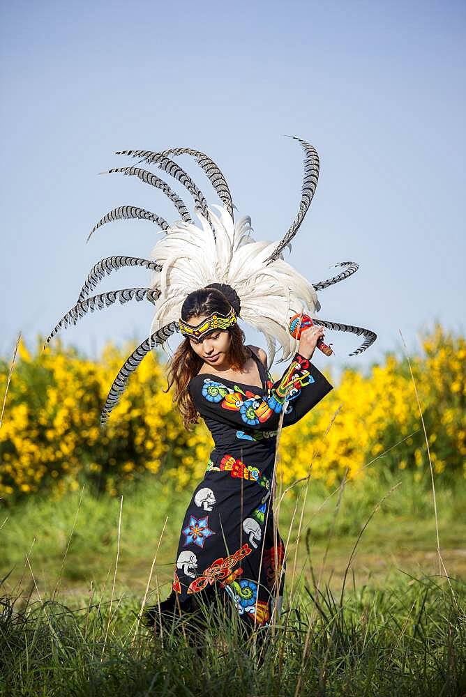 Native American woman in traditional headdress performing ceremony