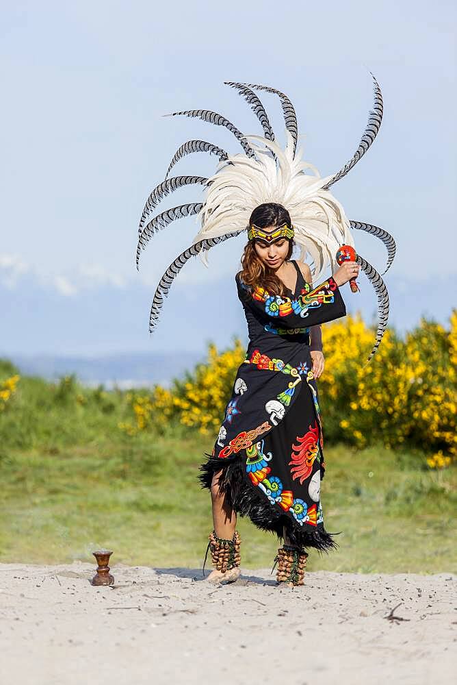 Native American woman in traditional headdress performing ceremony