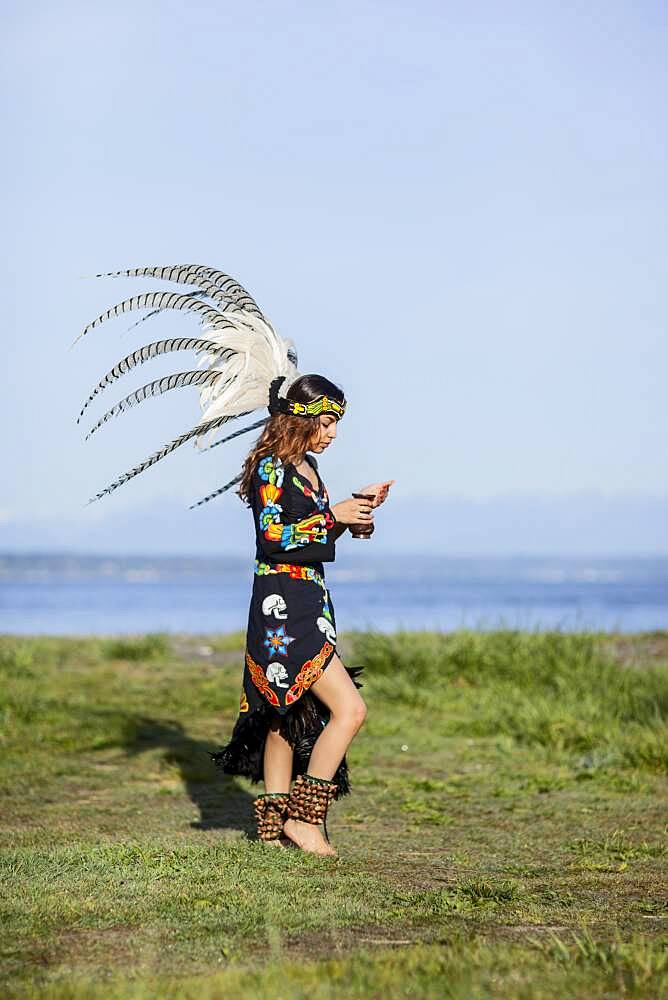 Native American woman in traditional headdress performing ceremony