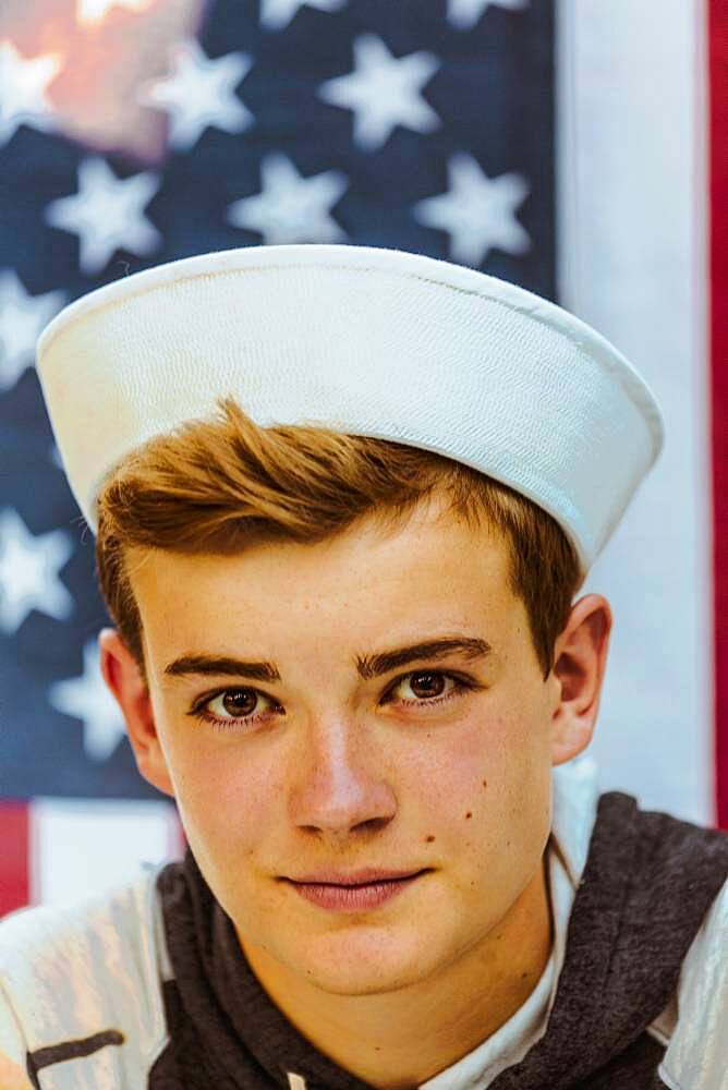 Caucasian teenage boy wearing sailor hat