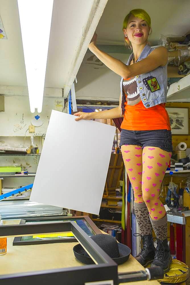 Caucasian artist working in screen print workshop