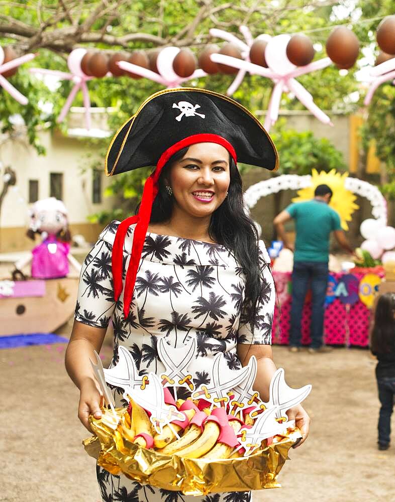 Hispanic woman serving snacks at party