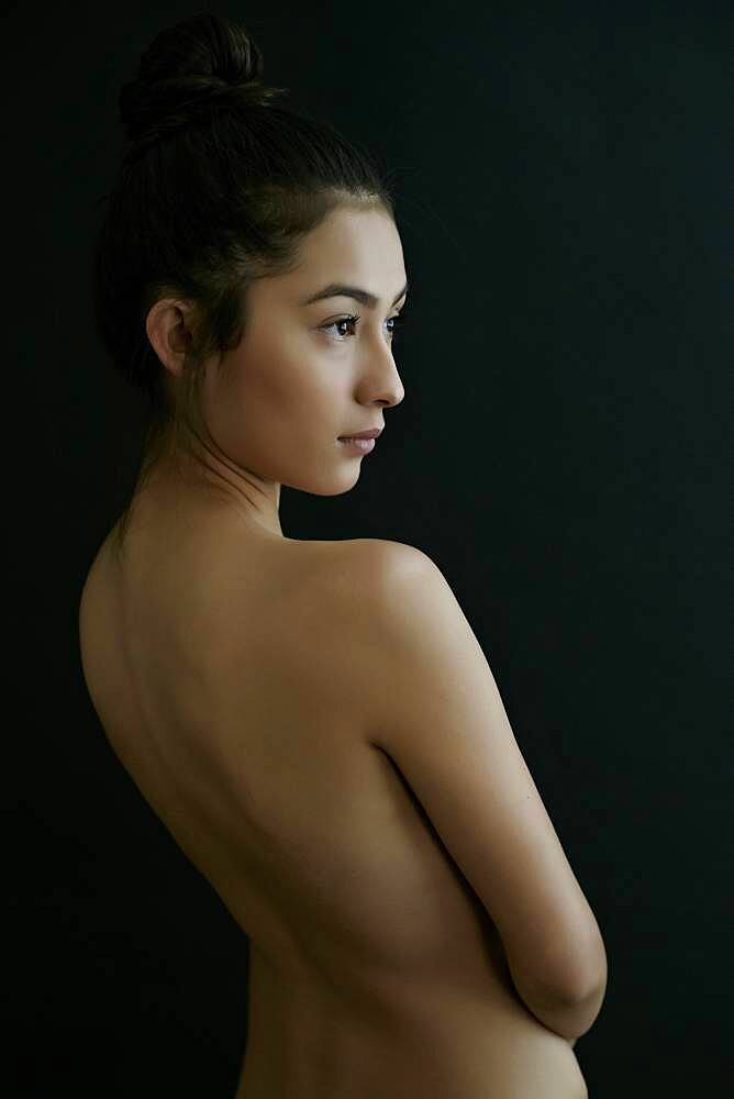 Nude Hispanic woman looking away