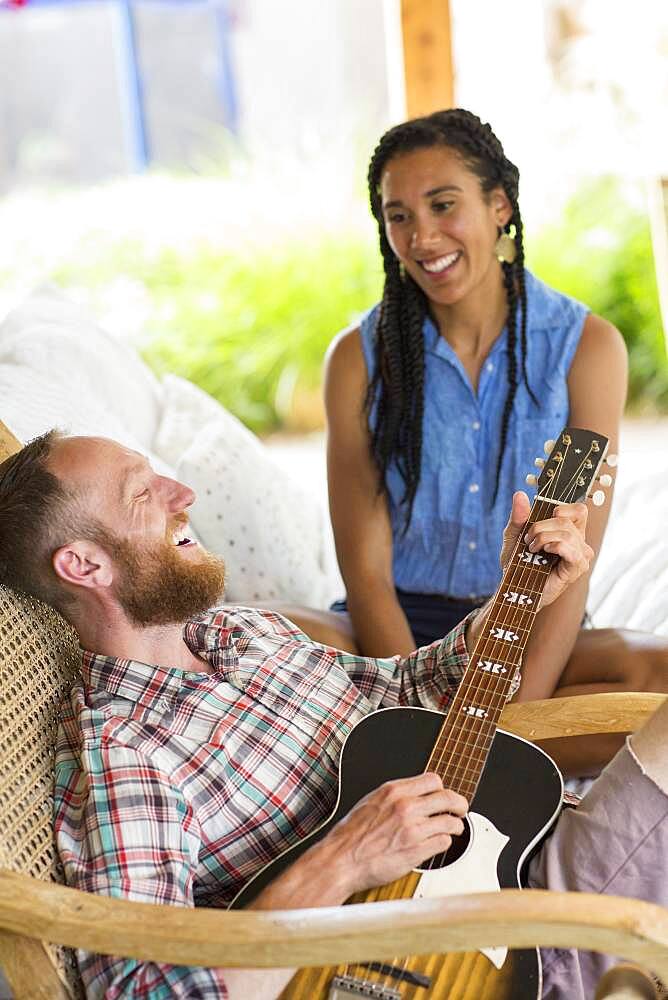 Couple playing music in backyard