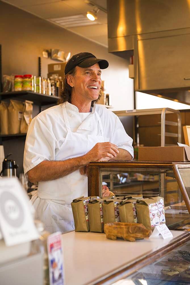 Caucasian baker working in bakery