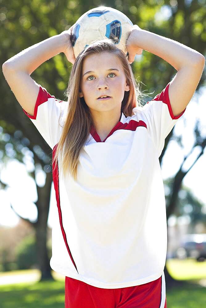 Caucasian soccer player throwing ball