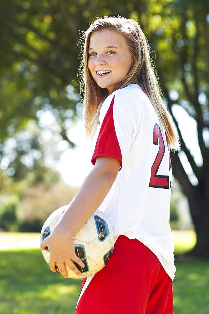 Caucasian soccer player holding ball