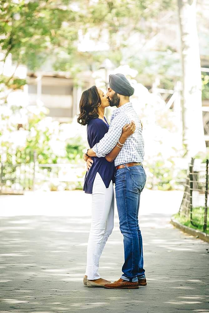 Indian couple kissing in urban park