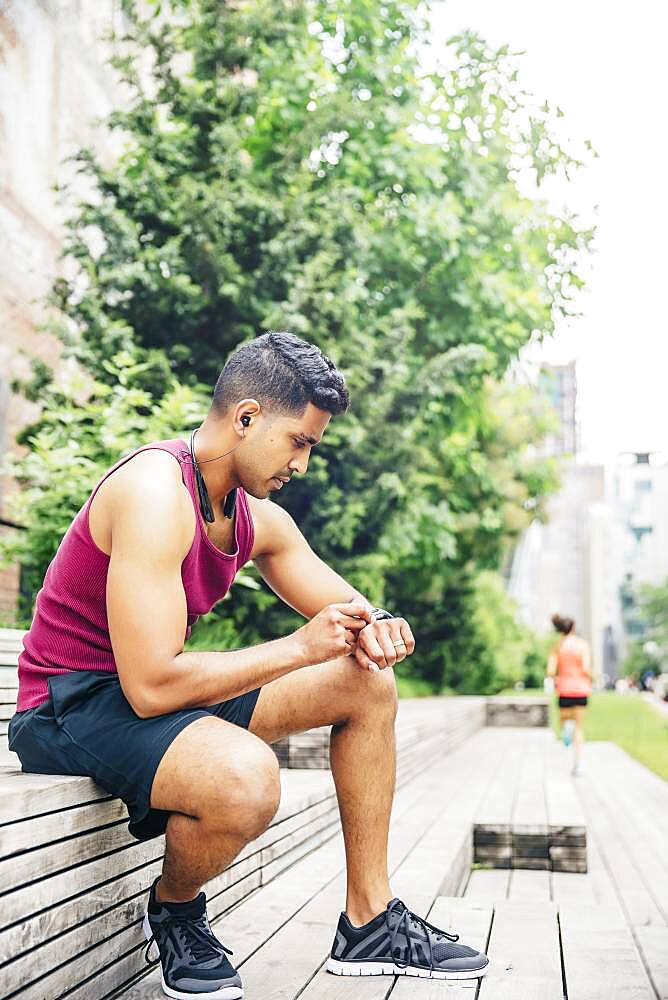 Indian athlete timing himself in city