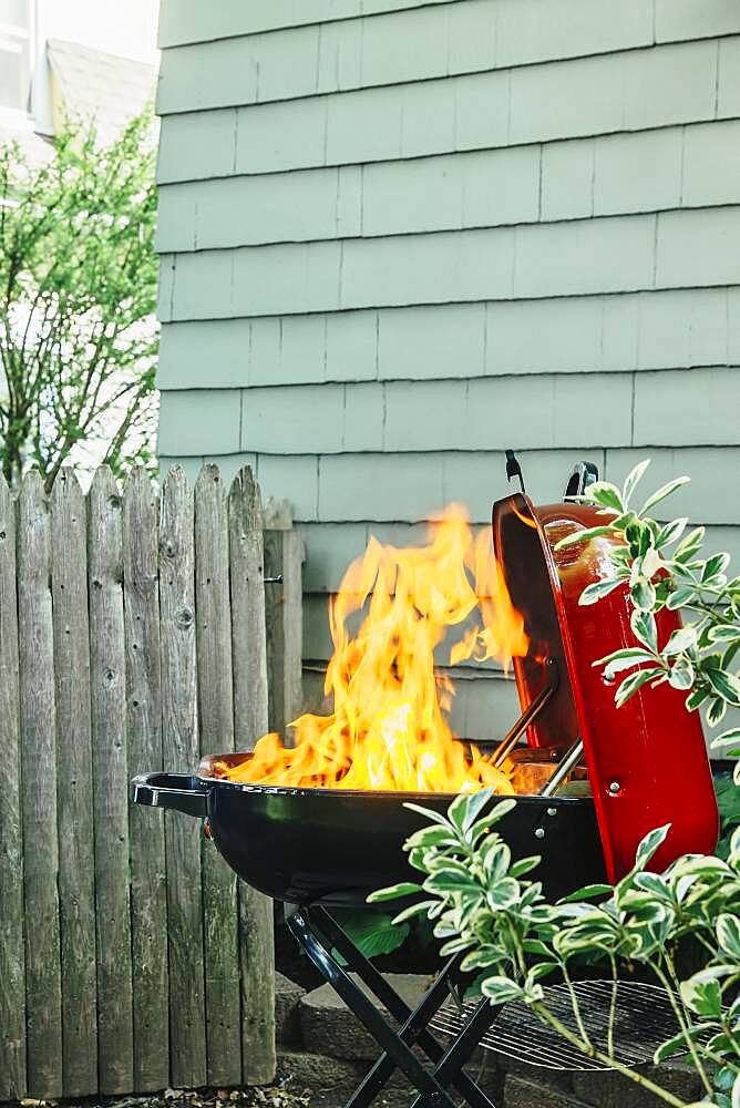 Fire burning on grill in backyard