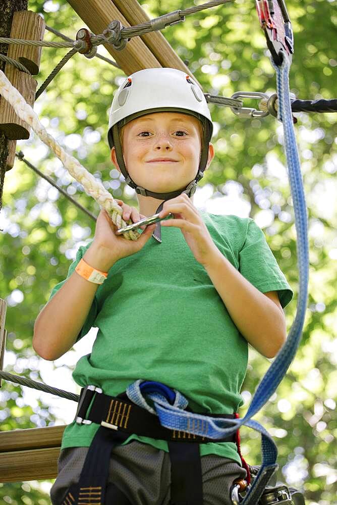 Caucasian boy hooking harness to line