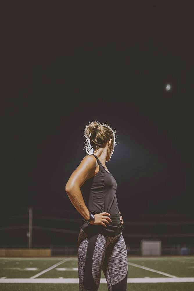 Caucasian athlete resting on sports field